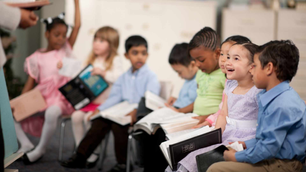Preschool children sitting together during a classroom reading activity.