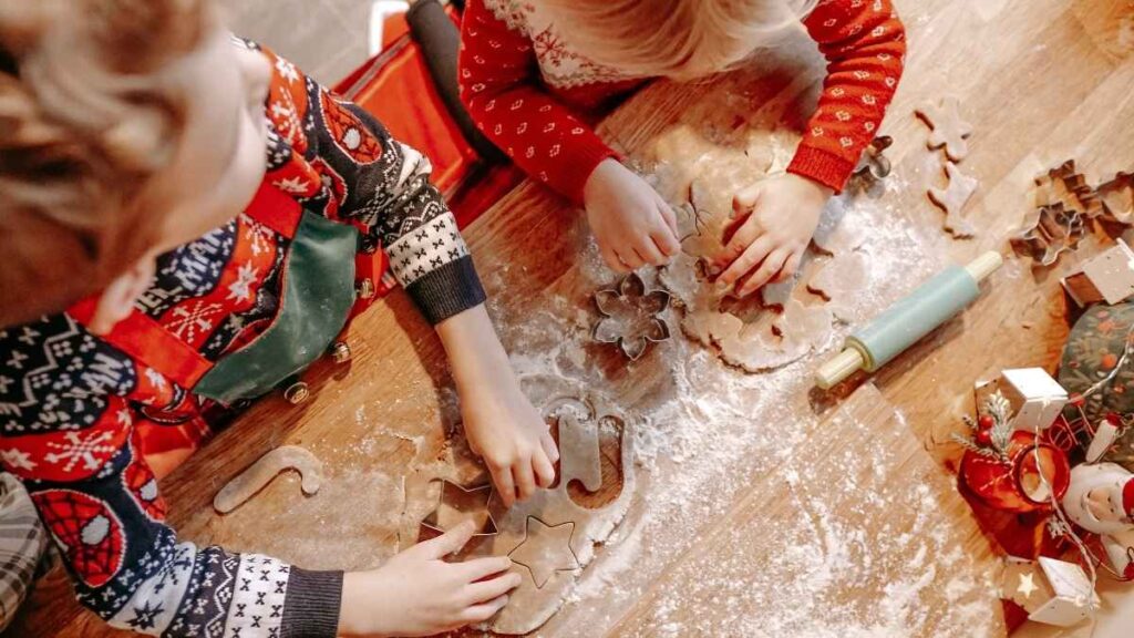 Children using cookie cutters and dough during a winter indoor activity.